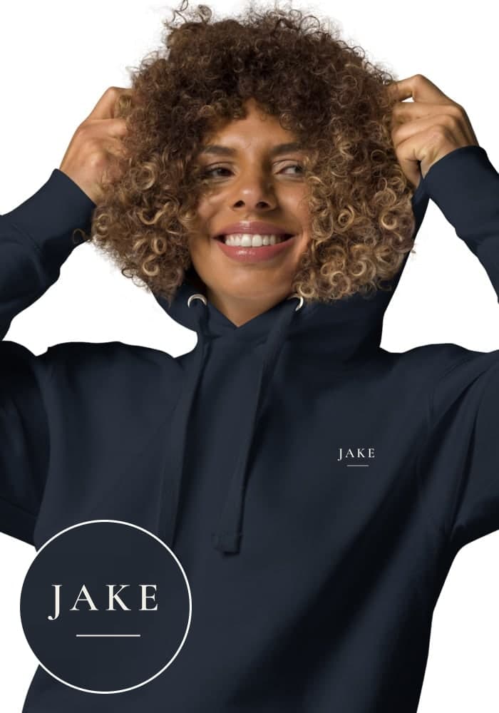 A navy hoodie with a name printed small on the left chest
